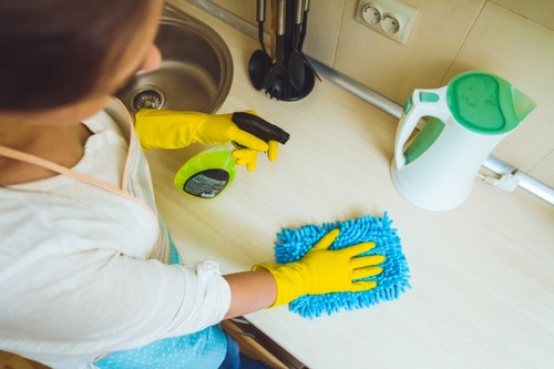 Kitchen surfaces being wiped as part of domestic cleaning